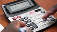 Closeup of person using calculator